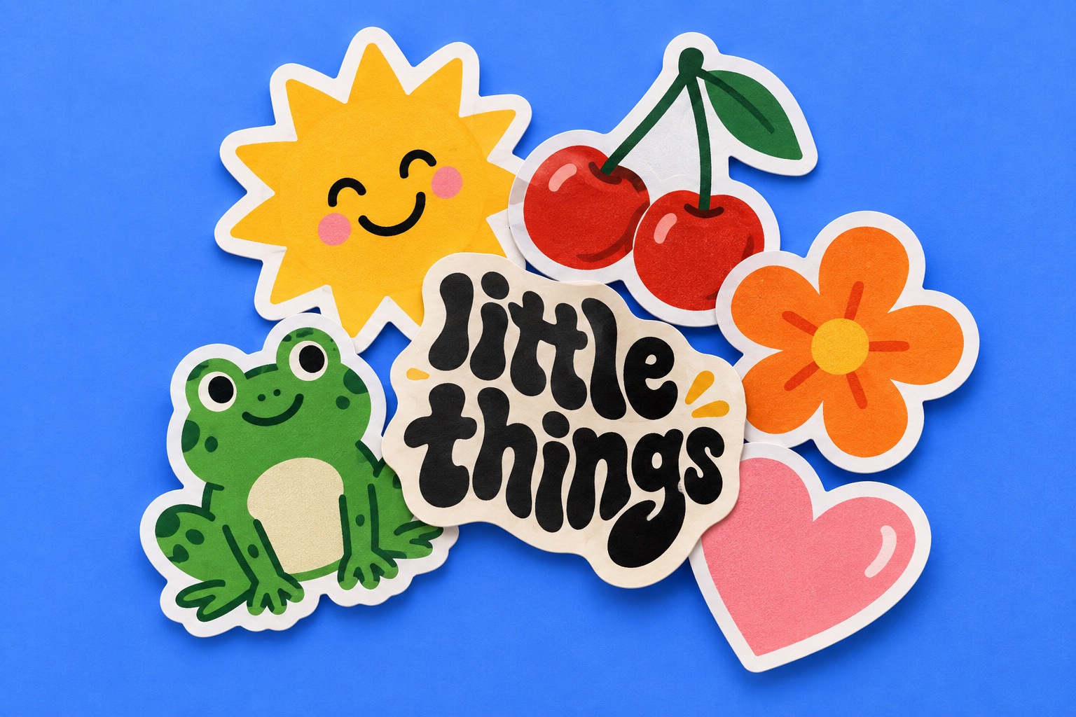 Colorful concept stickers: a sun, cherries, a frog, a flower, a heart, and little things lettering